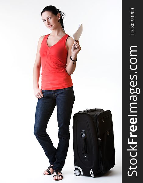 Charming traveler woman full-length standing next to her suitcase, holding in hand a ticket- ready for her summer travel. Shot in studio. Isolated on white. Charming traveler woman full-length standing next to her suitcase, holding in hand a ticket- ready for her summer travel. Shot in studio. Isolated on white.