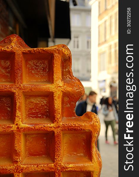 Big waffel on the road with blurred cityscape on background