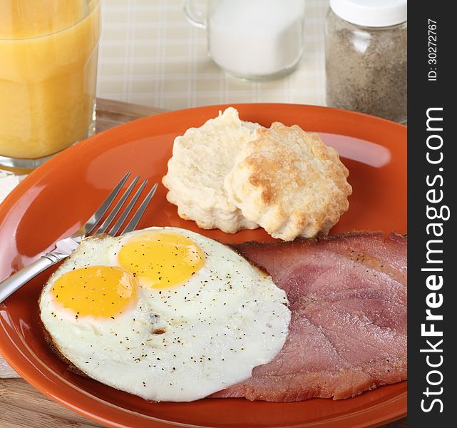Breakfast of two fried eggs sunny side up and slice of ham. Breakfast of two fried eggs sunny side up and slice of ham