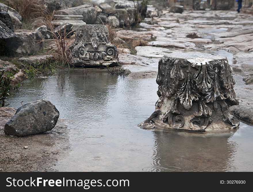 Ruined antique column in a rainy day