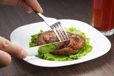 Cutting Grilled Steak With Knife On White Plate Stock Photography