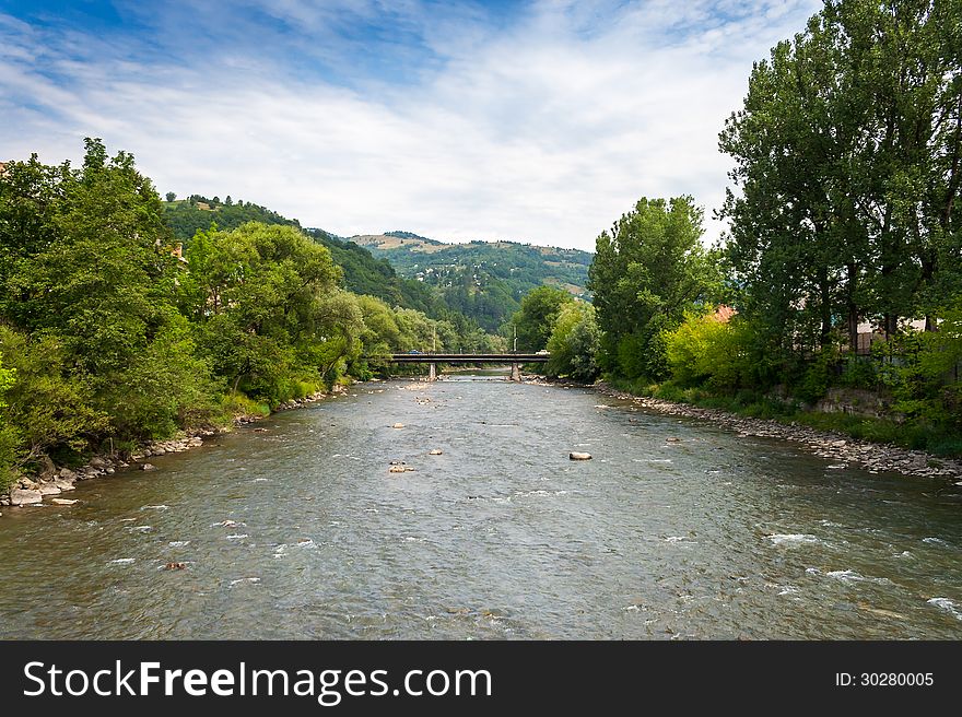 Landscape with mountains trees and a bridge through river. Landscape with mountains trees and a bridge through river