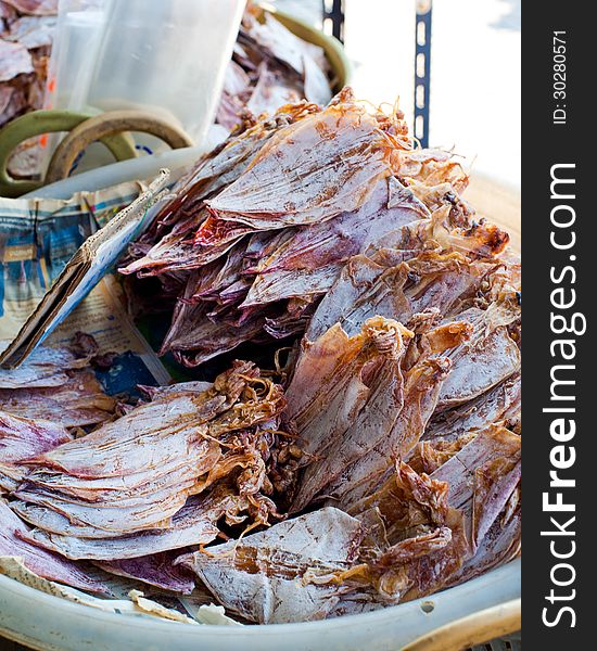 Sea food at market. Selling dry calamari in Thailand