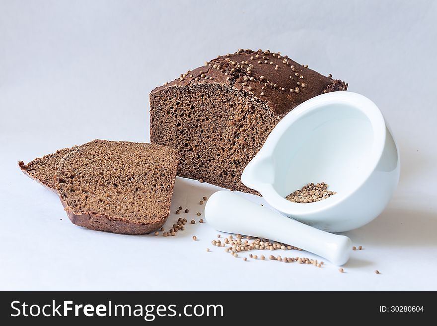 Traditional Russian black bread with coriander seeds with mortar spice