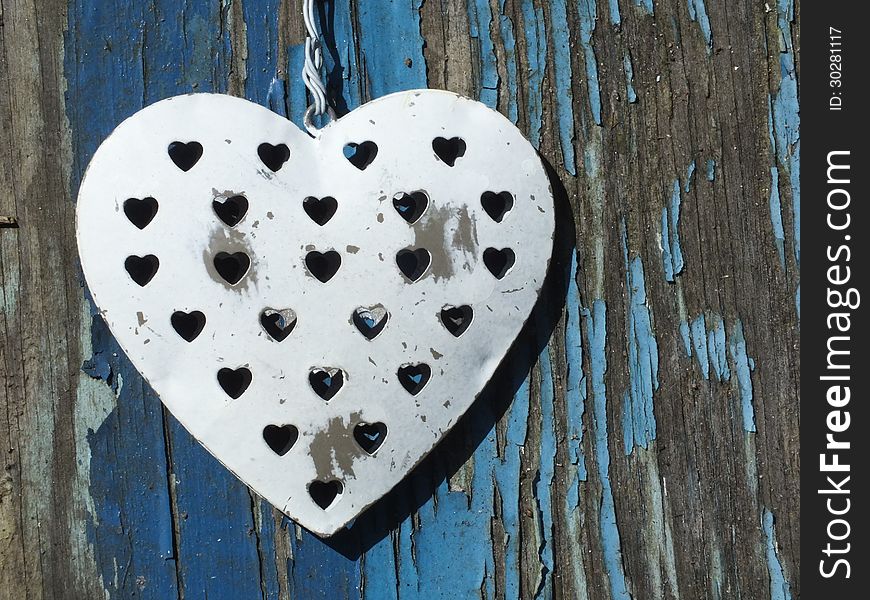 Shabby chic Metal Heart hanging on old blue grunge background. Shabby chic Metal Heart hanging on old blue grunge background