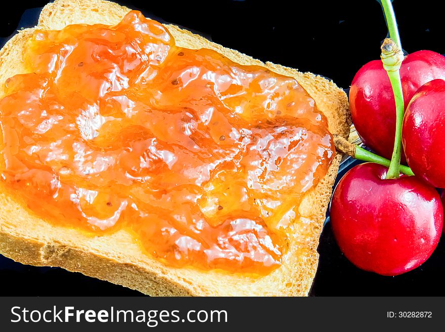 Jam, cherries and bread for a healty breakfast