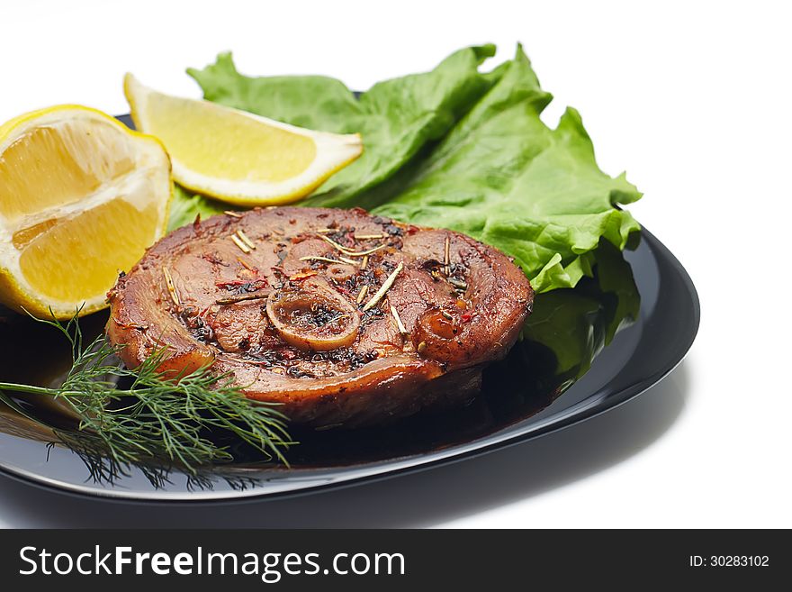 Grilled steak with salad and lemon