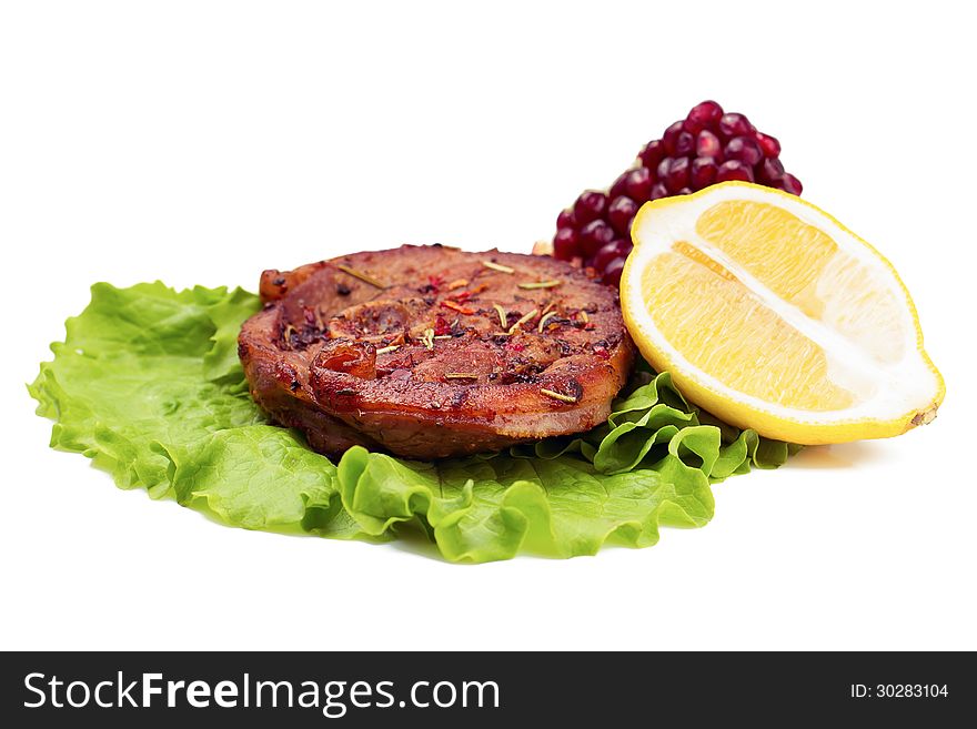 Grilled Turkey Steak With Lemon And Pomegranate On Leaf Of Salad