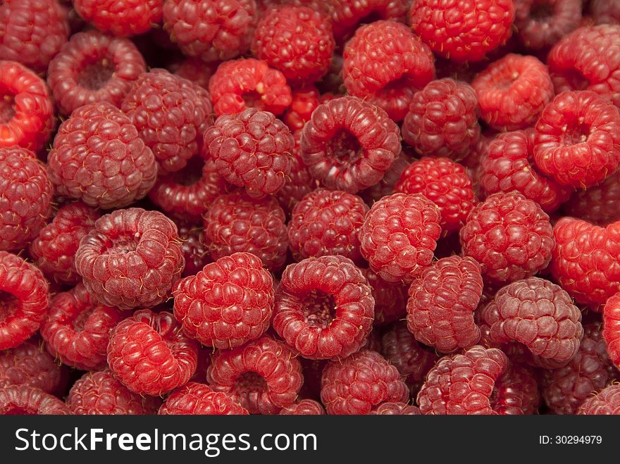 Fresh red ripe raspberries in a large mass. Fresh red ripe raspberries in a large mass