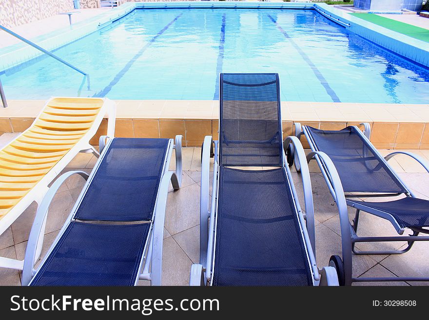 Pool with fresh and clear water and sunbeds. Pool with fresh and clear water and sunbeds