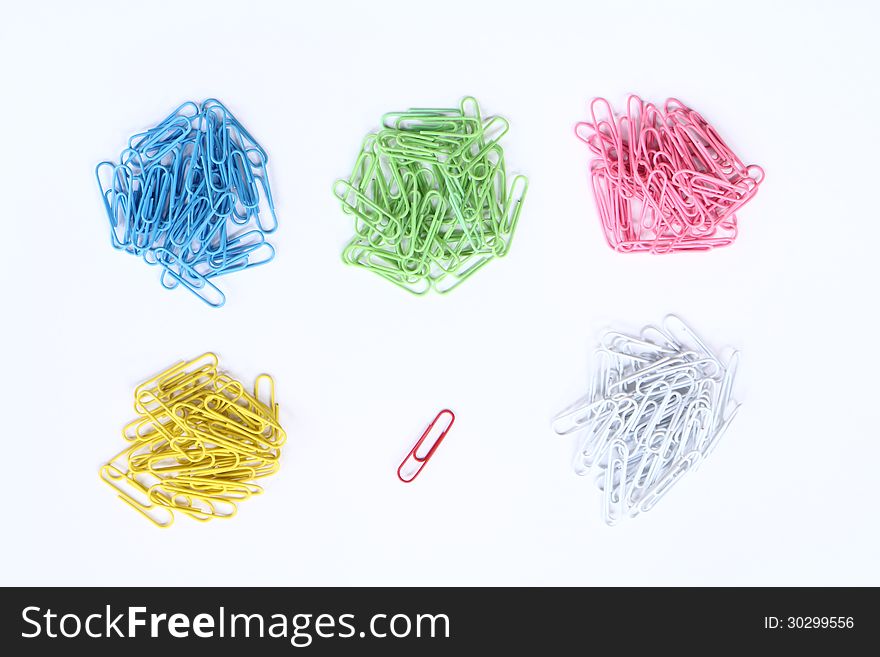 Piles of colour clippers and a single of red clipper isolated on white background