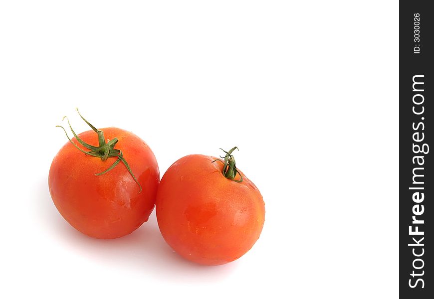 Two tomatoes on the white background