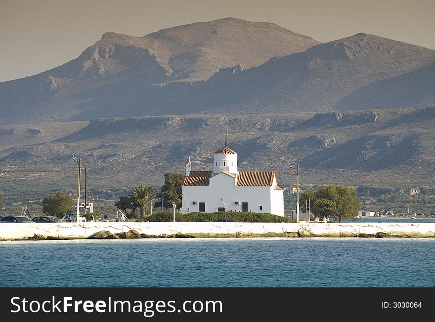 Antique white church on the island with mountains background. Antique white church on the island with mountains background