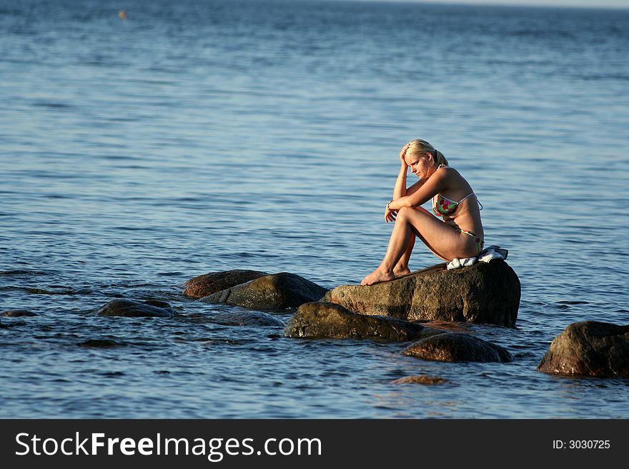 Girl sitting on the stone ,thinking