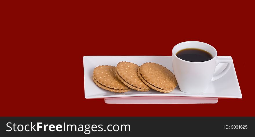 Cup  of  coffee and cream sandwich cookie  on the  plate. Cup  of  coffee and cream sandwich cookie  on the  plate