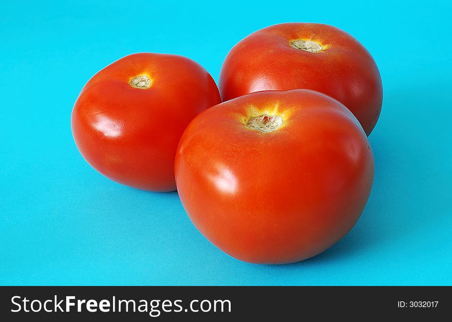 Three tomato on blue background. Three tomato on blue background