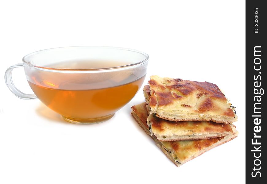 Tea cup with pie with cheese and parsley filling on white background