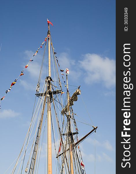 Masts of a sailing ship against a blue sky