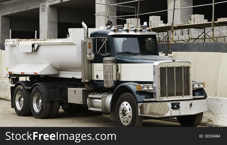 This truck is shown at the site of a parking garge under construction. This truck is shown at the site of a parking garge under construction