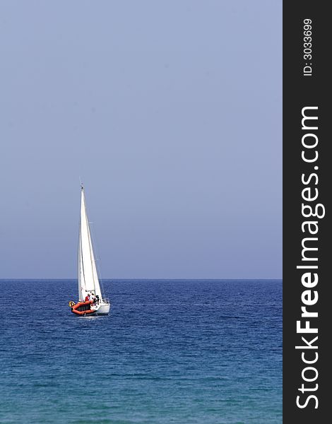 Sail boat cruising the coast of corsica, mediterranean