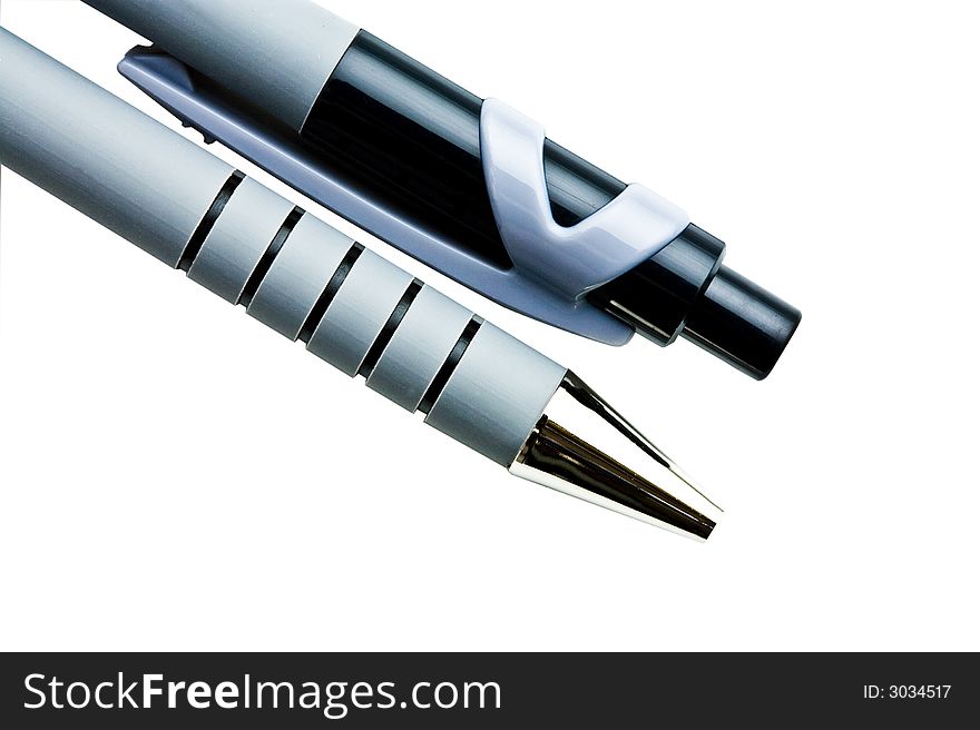 Macro close up of two ball point pens isolated over white