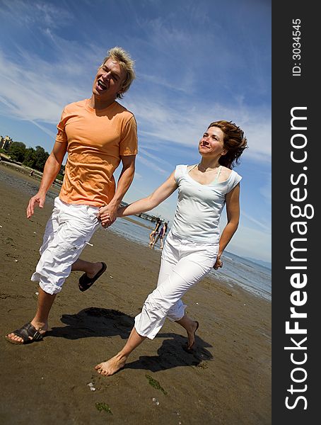 Young couple on the beach holding hands