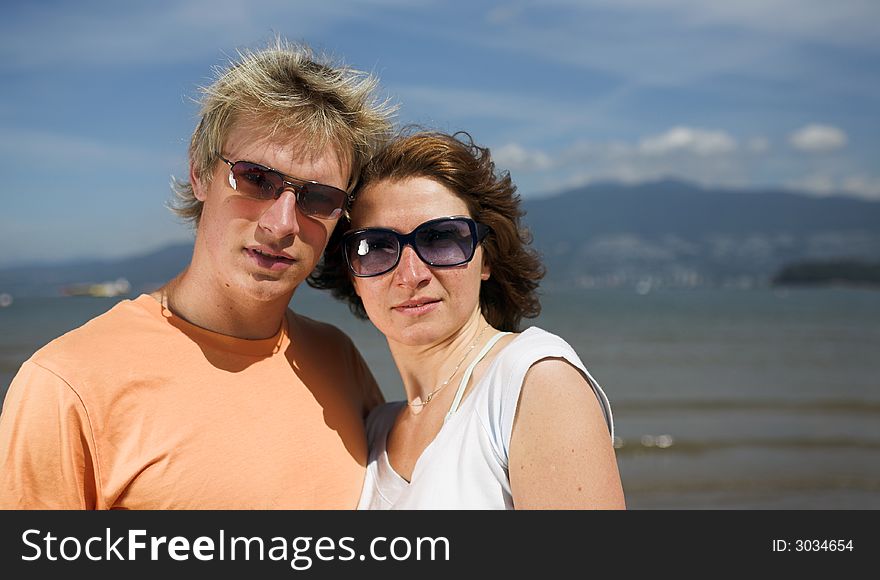 Young couple posing on the beach in vancouver. Young couple posing on the beach in vancouver