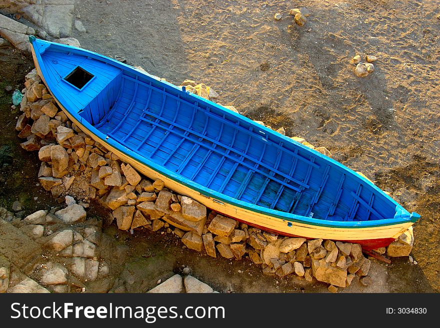 Blue fishing boat trapped on the dry land. Blue fishing boat trapped on the dry land.