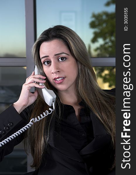 Business woman indoor shot sitting at her desk