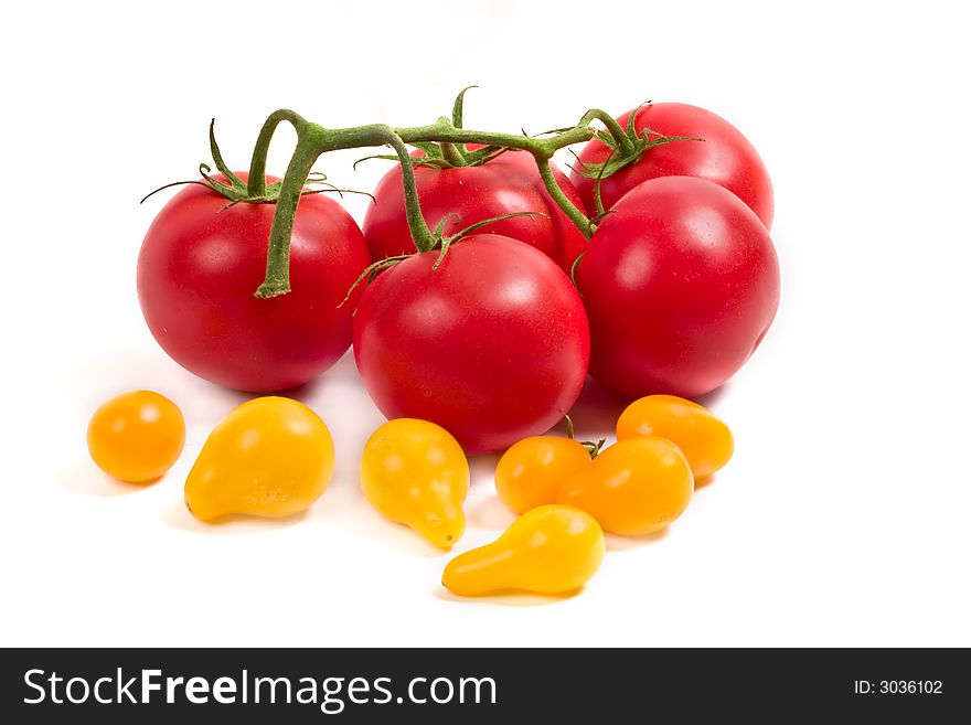 Red tomatoes on the vine and yellow tomatoes. Red tomatoes on the vine and yellow tomatoes