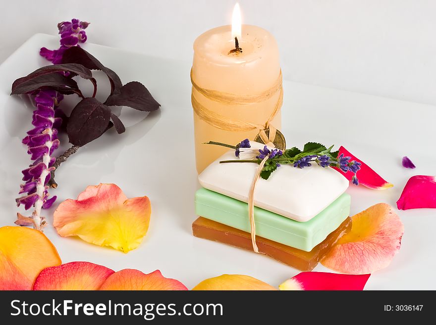 Soap bars and aromatic candle decorated with rose petals. Soap bars and aromatic candle decorated with rose petals