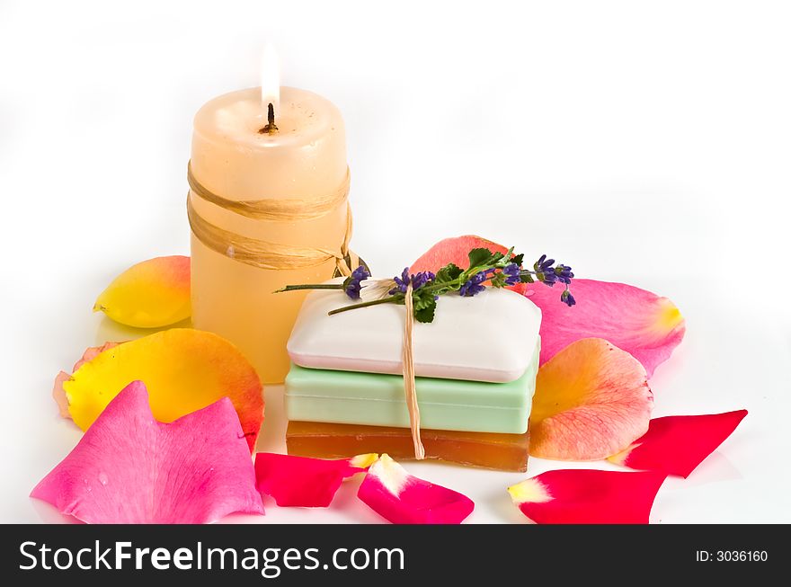 Soap bars and aromatic candle decorated with rose petals. Soap bars and aromatic candle decorated with rose petals