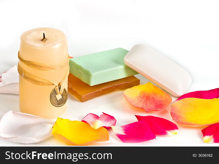 Soap bars and aromatic candle decorated with rose petals. Soap bars and aromatic candle decorated with rose petals