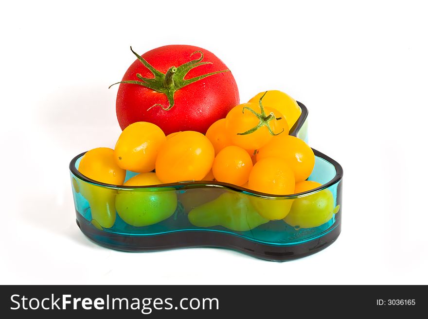 Red and yellow tomatoes in a glass tray