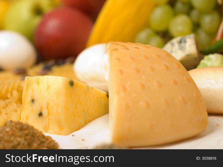 Cheese detail composition with fruits at background