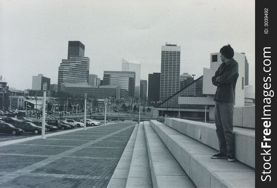 A guy standing , waiting on a friend. looking back at the town that shaped him. thinking, lonely. A guy standing , waiting on a friend. looking back at the town that shaped him. thinking, lonely.