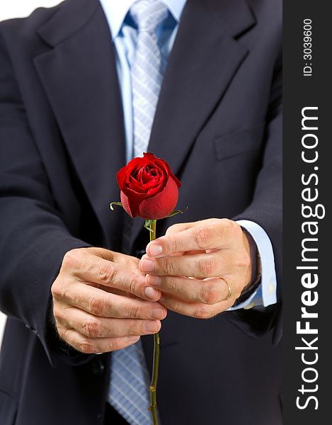 Man in business suit or dressed up giving single red rose as gift for valentine's day or to communicate his love. Man in business suit or dressed up giving single red rose as gift for valentine's day or to communicate his love