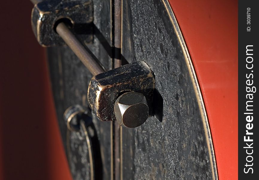 Close up of antique bolt lock on red lacquer cabinet. Close up of antique bolt lock on red lacquer cabinet