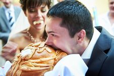 Groom Biting Loaf Of Bread Stock Photo Groom Biting Loaf Of Bread Stock Photo