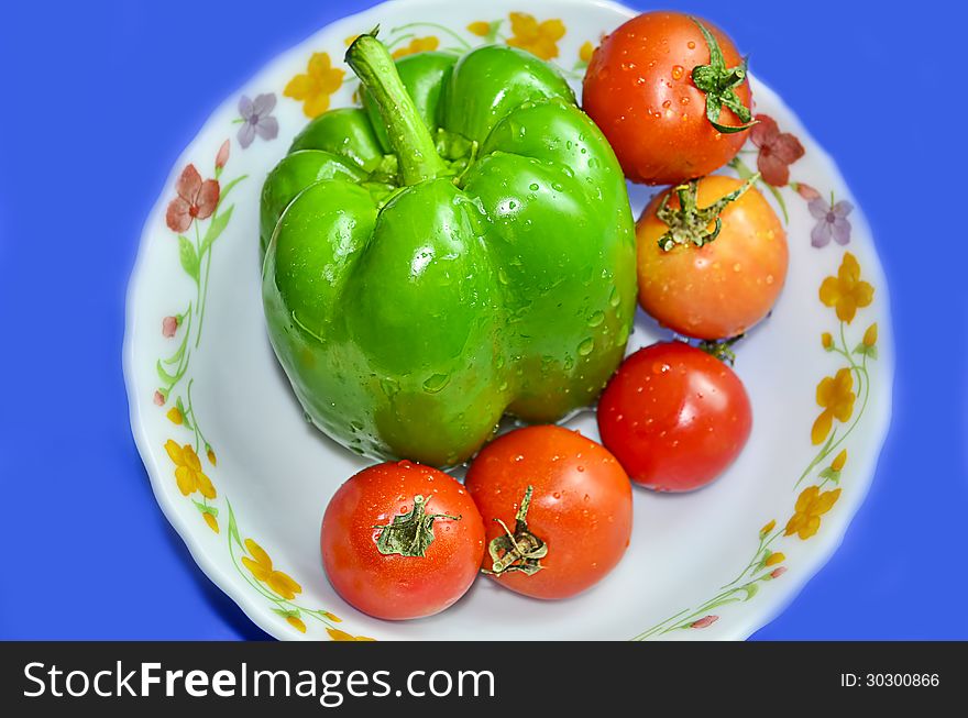 Green capcicum chilli and tomato with water drops on it