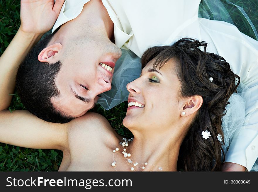 Happy bride and groom on grass