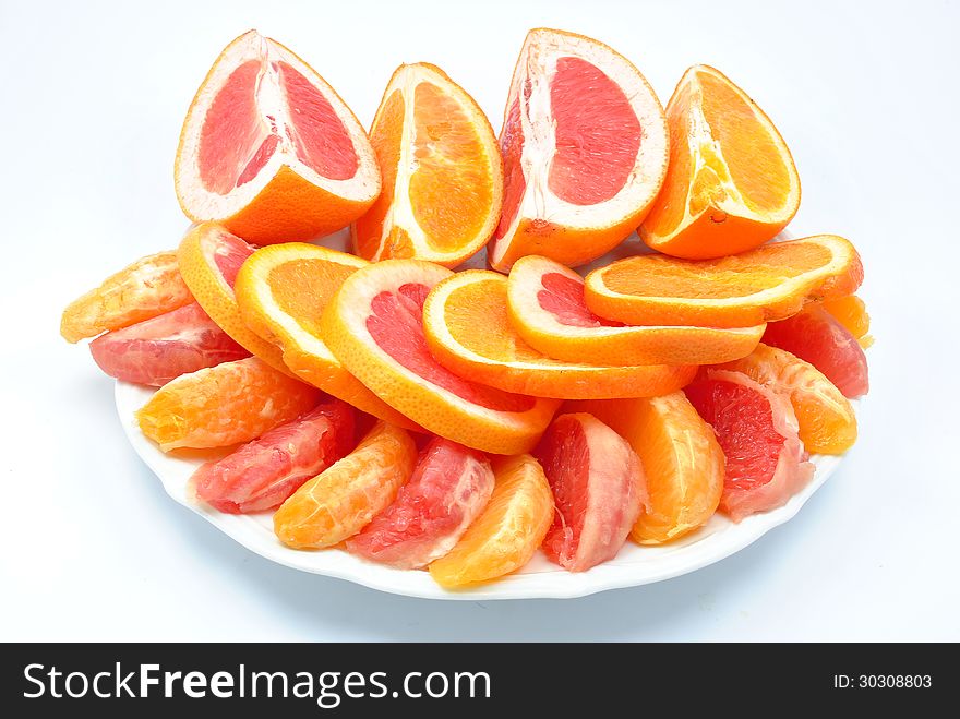 Grapefruit and oranges on a plate. Grapefruit and oranges on a plate