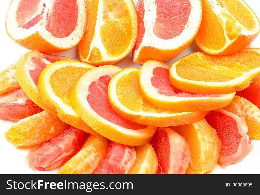 Grapefruit and oranges on a white background. Grapefruit and oranges on a white background