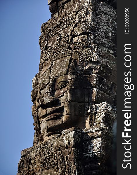 The carved face of Buddha in Bayon Temple, Angkor Wat. The carved face of Buddha in Bayon Temple, Angkor Wat