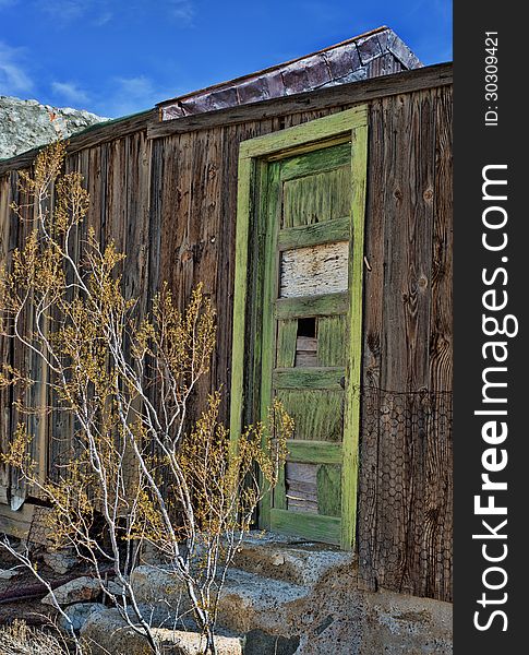 Green door of abandoned cabin