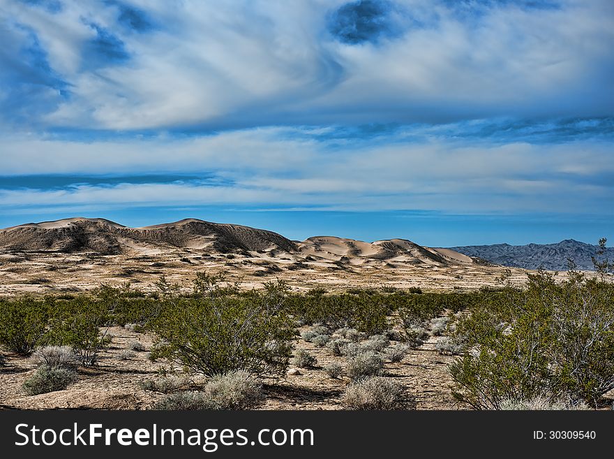 Kelso sand dunes in Mojave National monument with a beautiful dramatic sky in the back ground. Kelso sand dunes in Mojave National monument with a beautiful dramatic sky in the back ground