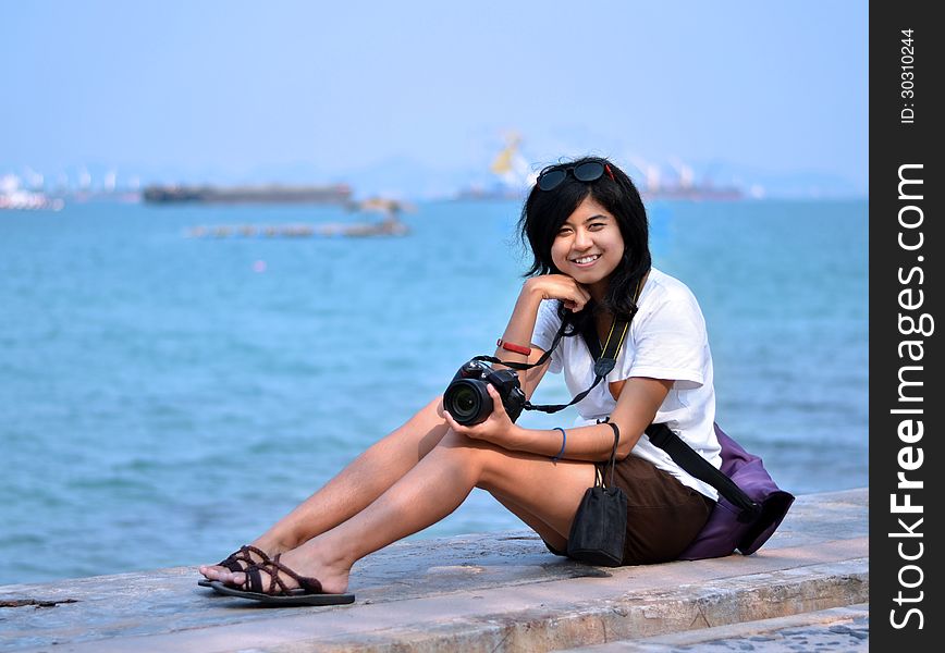 Young Woman Taking Pictures On The Beach