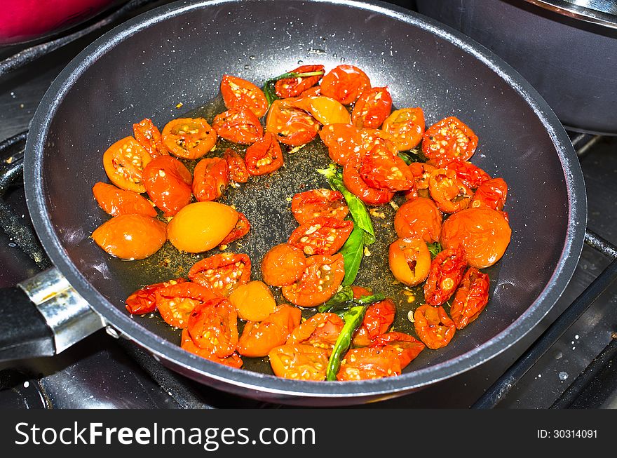 Some tomatoes cooked in a pot