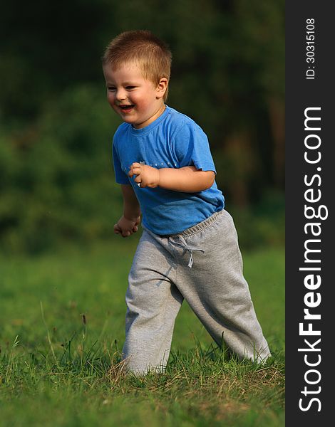 Little boy running in the grass