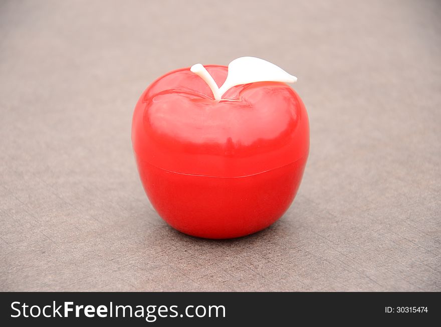 A red apple with white leaf